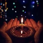 lighted candle on brown round holder