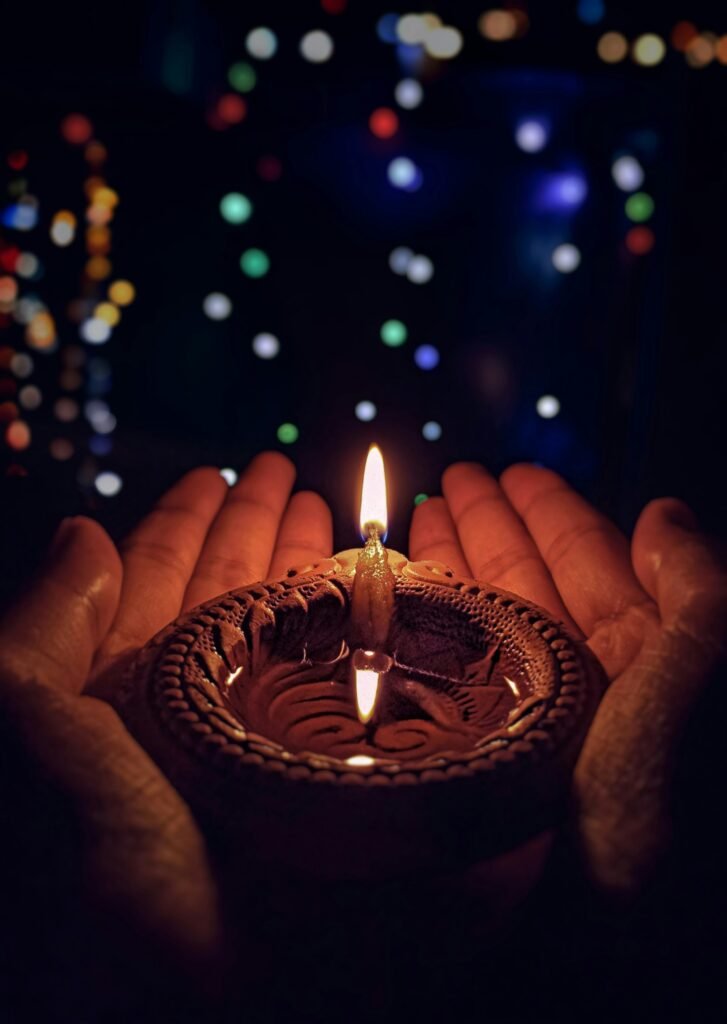 lighted candle on brown round holder